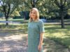 Gina standing in a park smiling at the camera