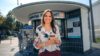 Woman standing in front of kiosk with coffee to go in hand